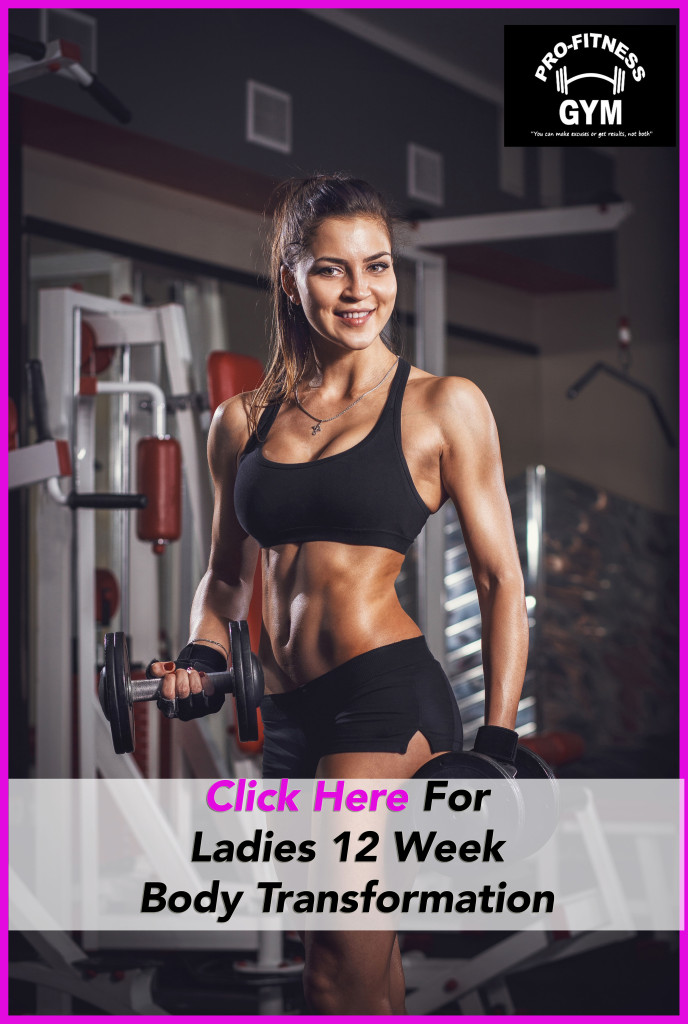 Sexy athlete with a dumbbell in the gym